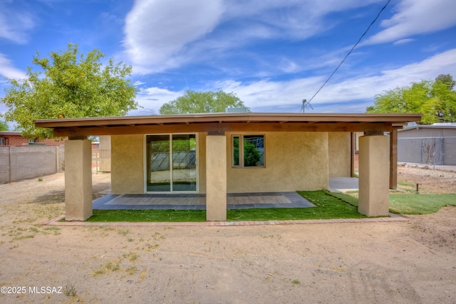 4842 E 27th St, Tucson, AZ 85711 - rear view of property with stucco siding, fence, and a patio area