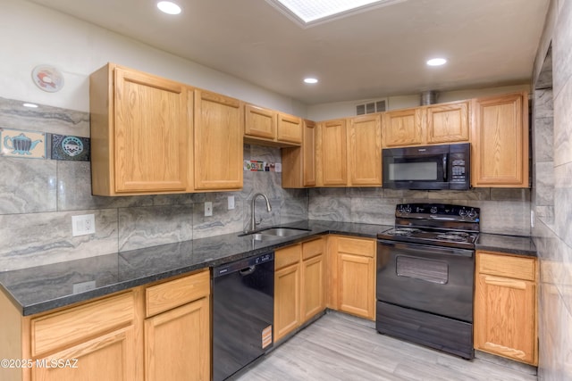 4842 E 27th St, Tucson, AZ 85711 - kitchen featuring black appliances, a sink, tasteful backsplash, light wood-type flooring, and dark stone countertops