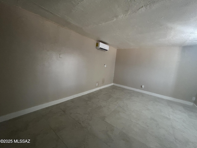 139 E 35th St, Tucson, AZ 85713 - bonus room featuring a wall mounted AC, baseboards, and a textured ceiling