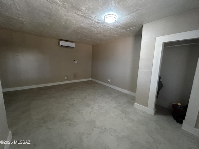 139 E 35th St, Tucson, AZ 85713 - finished basement with a wall mounted air conditioner, baseboards, and a textured ceiling