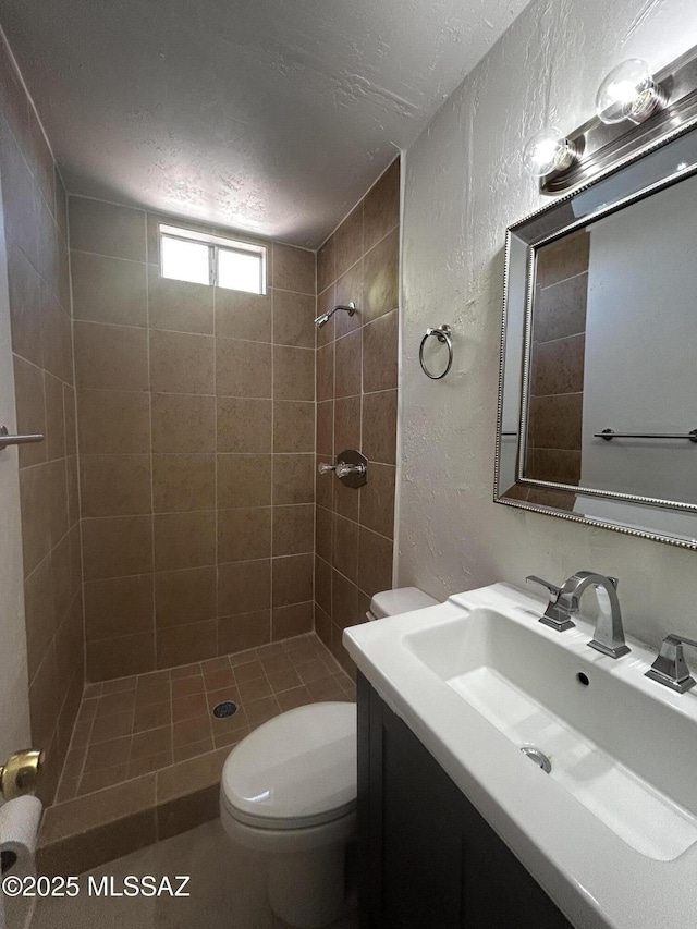 139 E 35th St, Tucson, AZ 85713 - full bath featuring a textured wall, vanity, a tile shower, and toilet