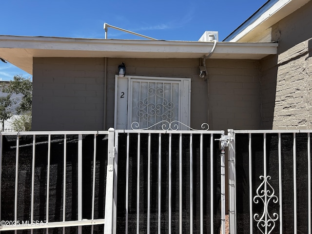 139 E 35th St, Tucson, AZ 85713 - doorway to property with concrete block siding and a gate