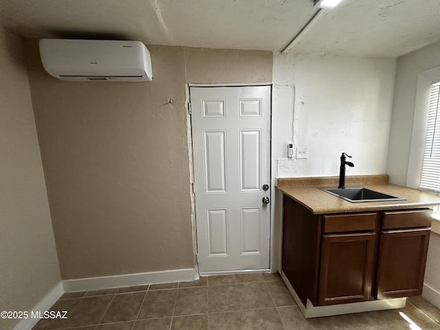139 E 35th St, Tucson, AZ 85713 - kitchen with a sink, an AC wall unit, tile patterned floors, light countertops, and dark brown cabinets