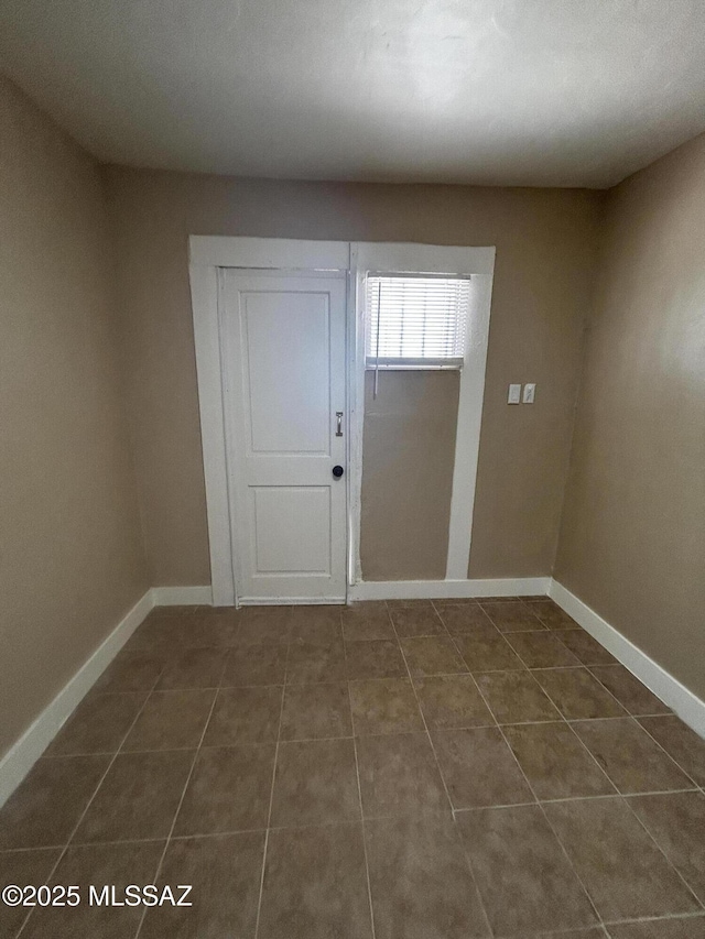 139 E 35th St, Tucson, AZ 85713 - entryway featuring dark tile patterned flooring and baseboards