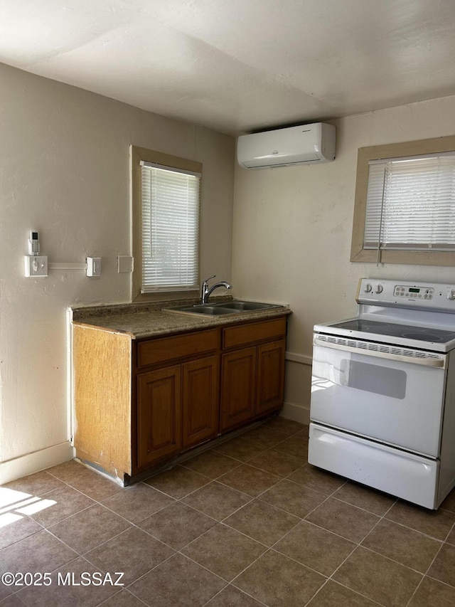 139 E 35th St, Tucson, AZ 85713 - kitchen featuring white electric range, a sink, an AC wall unit, brown cabinetry, and dark tile patterned flooring