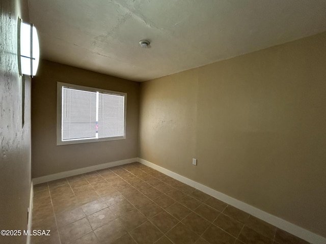 139 E 35th St, Tucson, AZ 85713 - unfurnished room featuring tile patterned floors, a smoke detector, and baseboards