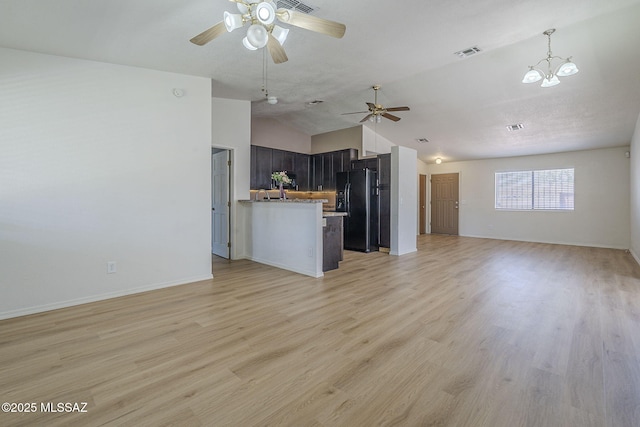 1741 W Maplewood Dr, Tucson, AZ 85746 - unfurnished living room with a ceiling fan, light wood finished floors, baseboards, a chandelier, and high vaulted ceiling