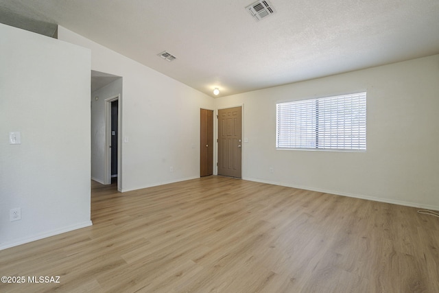 1741 W Maplewood Dr, Tucson, AZ 85746 - empty room with lofted ceiling, light wood finished floors, and baseboards