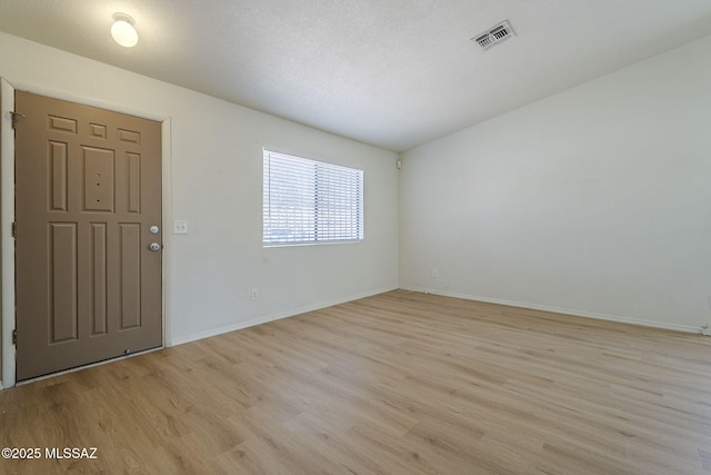 1741 W Maplewood Dr, Tucson, AZ 85746 - spare room with light wood-type flooring and baseboards