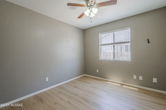 1741 W Maplewood Dr, Tucson, AZ 85746 - unfurnished room with light wood-style floors, baseboards, and a ceiling fan
