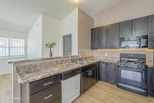 1741 W Maplewood Dr, Tucson, AZ 85746 - kitchen with black appliances, a peninsula, a sink, lofted ceiling, and light wood-style flooring