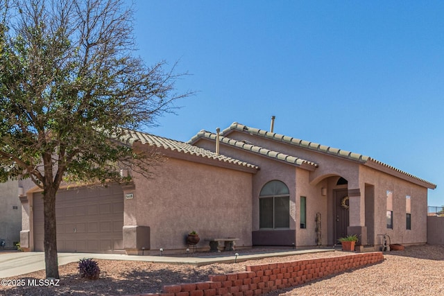 5608 Shady Grove, Tucson, AZ 85742 - view of front of house featuring an attached garage, concrete driveway, stucco siding, and a tile roof