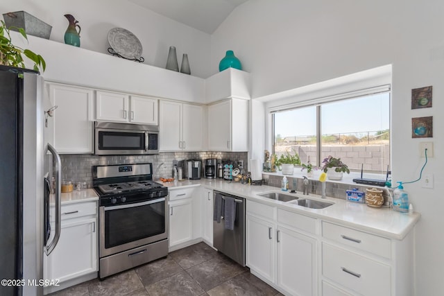 5608 Shady Grove, Tucson, AZ 85742 - kitchen with stainless steel appliances, a sink, backsplash, vaulted ceiling, and light countertops