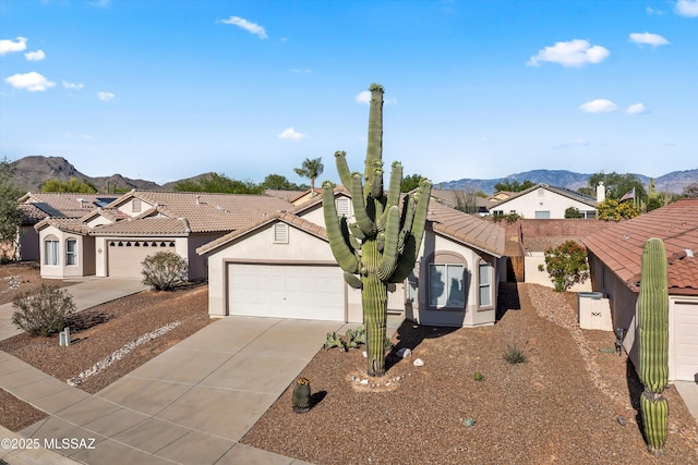 12688 N Wild Indigo Dr, Marana, AZ 85658 - view of front of house with a mountain view, a garage, and concrete driveway