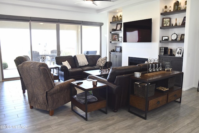 8867 S Welsh Pl, Hereford, AZ 85615 - living room featuring wood finished floors, ceiling fan, and a fireplace