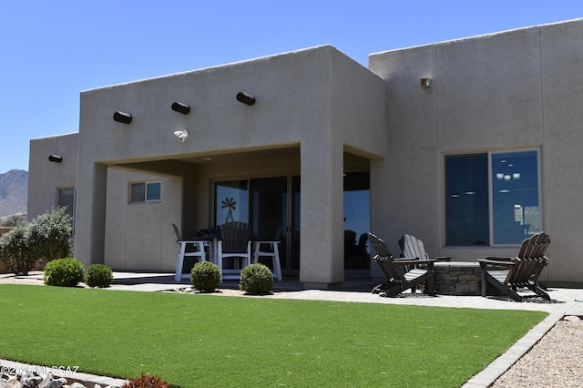 8867 S Welsh Pl, Hereford, AZ 85615 - rear view of house featuring a patio area, stucco siding, a fire pit, and a yard