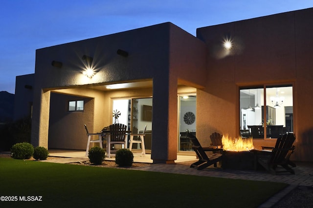 8867 S Welsh Pl, Hereford, AZ 85615 - rear view of house featuring an outdoor fire pit, a patio, and stucco siding