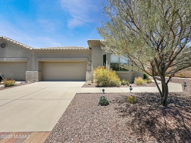 13401 N Rancho Vistoso Blvd Unit 190, Oro Valley, AZ 85755 - view of front of property featuring a garage, a tiled roof, stucco siding, and concrete driveway