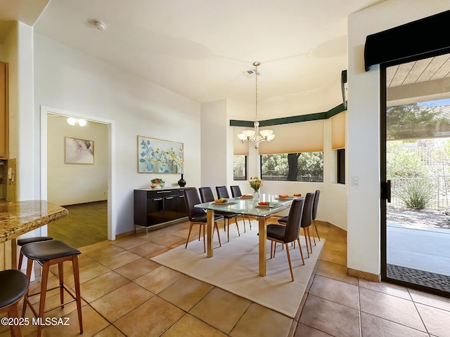 13401 N Rancho Vistoso Blvd Unit 190, Oro Valley, AZ 85755 - dining area with a towering ceiling, a chandelier, light tile patterned flooring, and baseboards