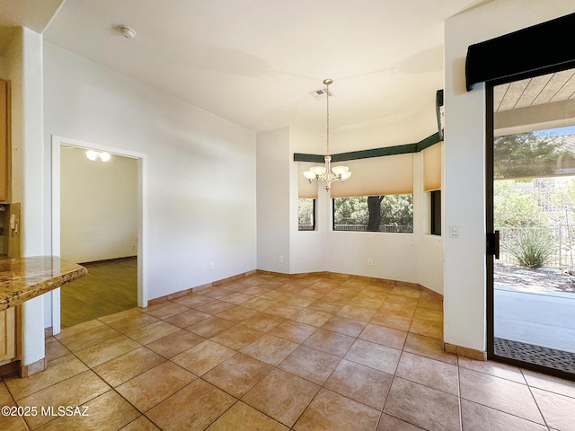13401 N Rancho Vistoso Blvd Unit 190, Oro Valley, AZ 85755 - unfurnished dining area featuring a chandelier, a towering ceiling, and light tile patterned floors