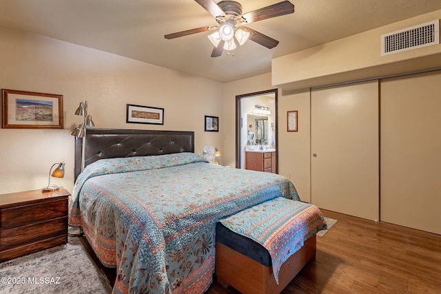 413 N Calle Del Diablo, Green Valley, AZ 85614 - bedroom with wood finished floors, a closet, ceiling fan, and ensuite bath
