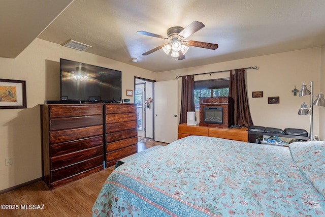 413 N Calle Del Diablo, Green Valley, AZ 85614 - bedroom with wood finished floors, baseboards, and a ceiling fan