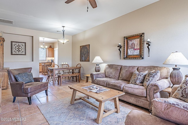 1012 W Via Del Placio, Green Valley, AZ 85614 - living room with a ceiling fan, light tile patterned floors, and a chandelier