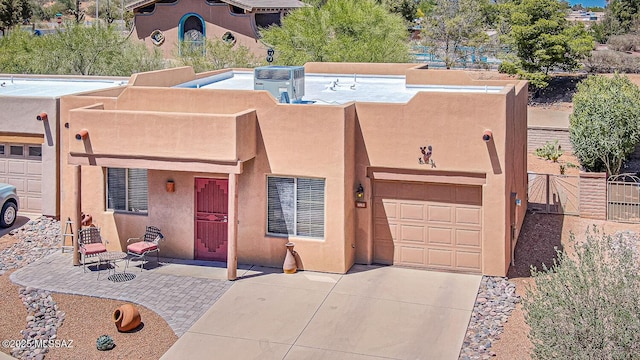 1012 W Via Del Placio, Green Valley, AZ 85614 - southwest-style home featuring stucco siding, concrete driveway, a garage, and central air condition unit