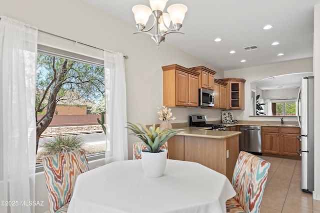 45 N Lookout Knob Dr, Sahuarita, AZ 85629 - kitchen with appliances with stainless steel finishes, arched walkways, a chandelier, light tile patterned floors, and glass insert cabinets