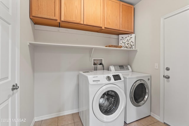 45 N Lookout Knob Dr, Sahuarita, AZ 85629 - washroom featuring cabinet space, washer and dryer, baseboards, and light tile patterned floors