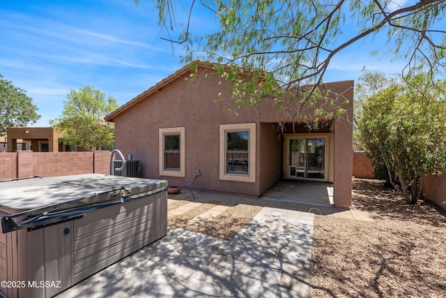 45 N Lookout Knob Dr, Sahuarita, AZ 85629 - rear view of property featuring a hot tub, a fenced backyard, stucco siding, and a patio