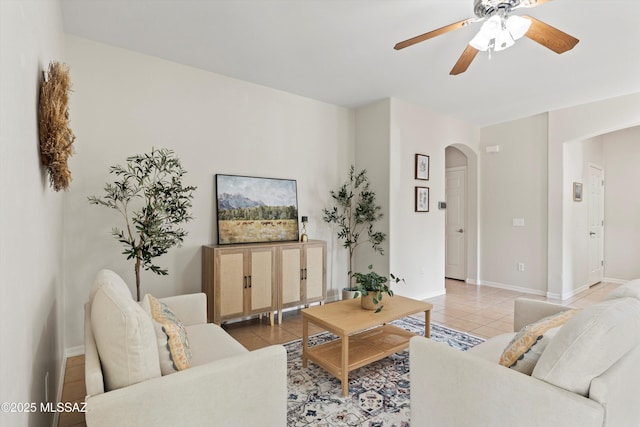 45 N Lookout Knob Dr, Sahuarita, AZ 85629 - living room with arched walkways, light tile patterned floors, ceiling fan, and baseboards