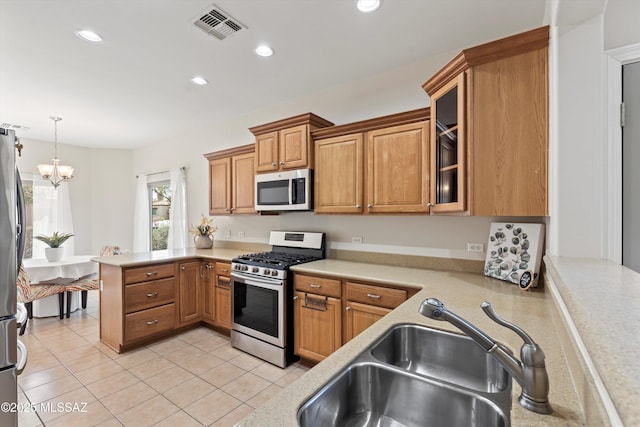 45 N Lookout Knob Dr, Sahuarita, AZ 85629 - kitchen featuring appliances with stainless steel finishes, a sink, light countertops, a peninsula, and light tile patterned floors