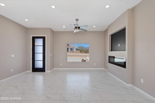 1814 Cajeme Ct, Rio Rico, AZ 85648 - unfurnished living room with light marble finish floors, a ceiling fan, a glass covered fireplace, recessed lighting, and baseboards
