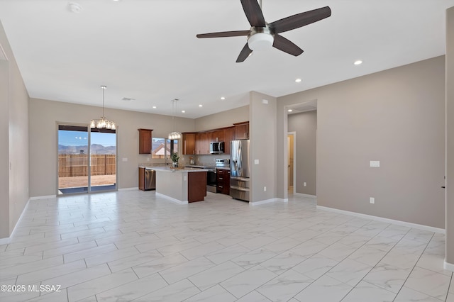 1814 Cajeme Ct, Rio Rico, AZ 85648 - kitchen featuring open floor plan, appliances with stainless steel finishes, light countertops, a ceiling fan, and a center island