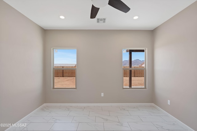1814 Cajeme Ct, Rio Rico, AZ 85648 - empty room featuring light marble finish floors, recessed lighting, ceiling fan, and baseboards