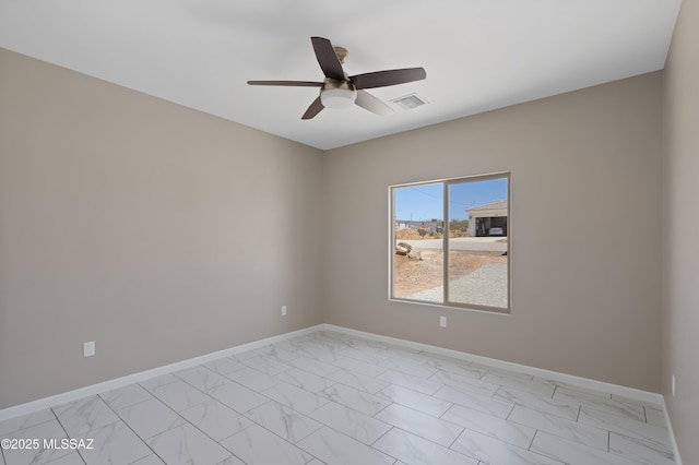 1814 Cajeme Ct, Rio Rico, AZ 85648 - spare room with light marble finish flooring, a ceiling fan, and baseboards