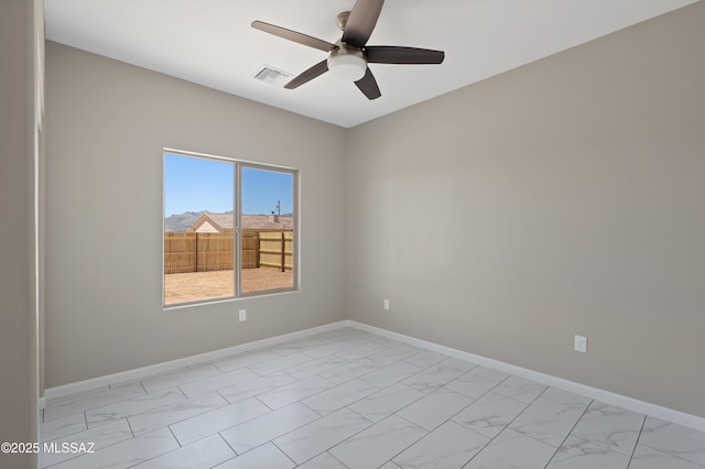 1814 Cajeme Ct, Rio Rico, AZ 85648 - unfurnished room featuring light marble finish floors, a ceiling fan, and baseboards