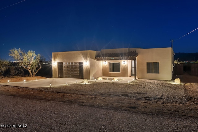 1814 Cajeme Ct, Rio Rico, AZ 85648 - pueblo-style house featuring stucco siding, an attached garage, and concrete driveway