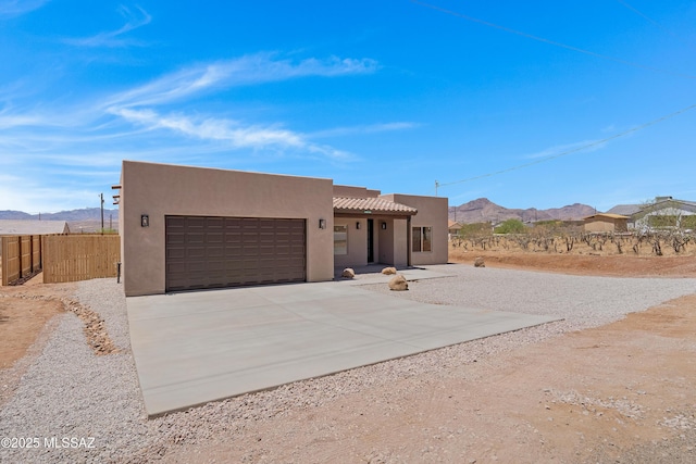 1814 Cajeme Ct, Rio Rico, AZ 85648 - southwest-style home with an attached garage, stucco siding, driveway, and a mountain view