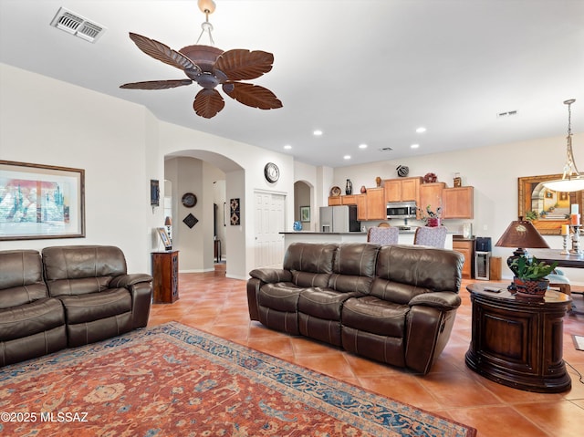 380 E Via Puente De La Lluvia, Sahuarita, AZ 85629 - living room with arched walkways, light tile patterned floors, a ceiling fan, and recessed lighting