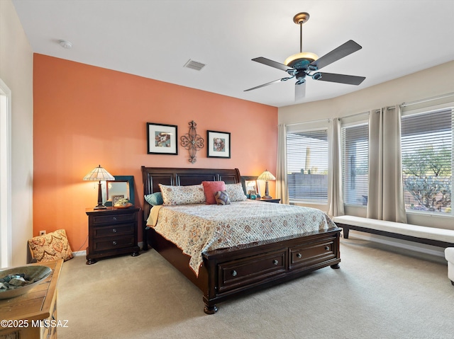 380 E Via Puente De La Lluvia, Sahuarita, AZ 85629 - bedroom featuring light colored carpet, multiple windows, a ceiling fan, and baseboards