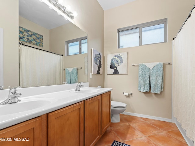 380 E Via Puente De La Lluvia, Sahuarita, AZ 85629 - full bath featuring toilet, double vanity, tile patterned flooring, a shower with shower curtain, and baseboards