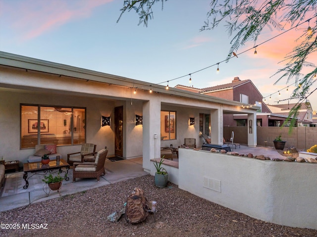 380 E Via Puente De La Lluvia, Sahuarita, AZ 85629 - rear view of house featuring a patio, stucco siding, and an outdoor living space