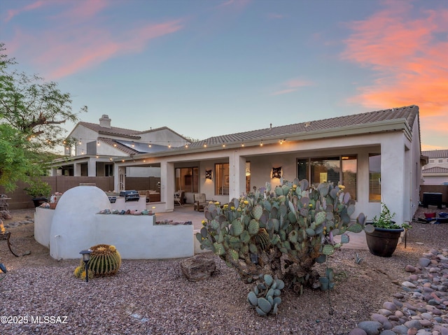 380 E Via Puente De La Lluvia, Sahuarita, AZ 85629 - rear view of property with a patio area, stucco siding, a chimney, an outdoor hangout area, and a tile roof