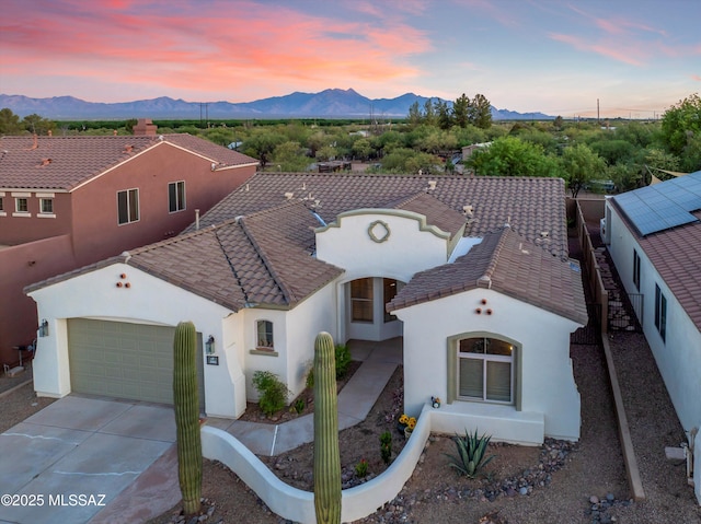 380 E Via Puente De La Lluvia, Sahuarita, AZ 85629 - view of front facade featuring stucco siding, a mountain view, and concrete driveway