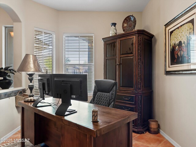 380 E Via Puente De La Lluvia, Sahuarita, AZ 85629 - home office featuring arched walkways, baseboards, and light tile patterned flooring