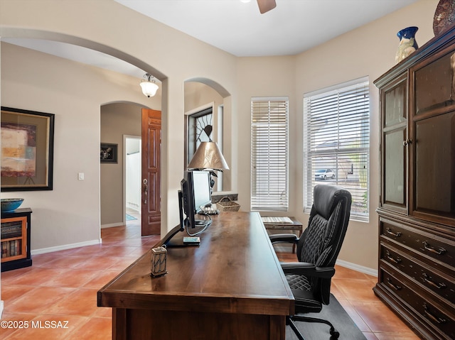 380 E Via Puente De La Lluvia, Sahuarita, AZ 85629 - office area with arched walkways, light tile patterned floors, ceiling fan, and baseboards