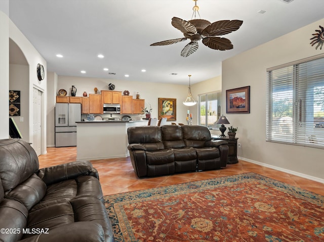 380 E Via Puente De La Lluvia, Sahuarita, AZ 85629 - living room featuring light tile patterned flooring, a ceiling fan, arched walkways, recessed lighting, and baseboards