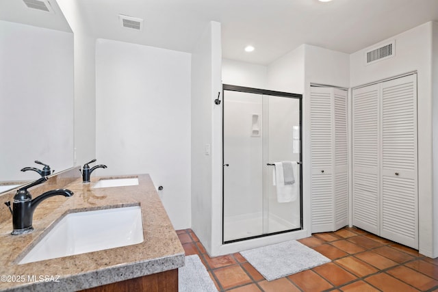 2302 N Norton Ave, Tucson, AZ 85719 - bathroom featuring a closet, a stall shower, double vanity, recessed lighting, and tile patterned flooring